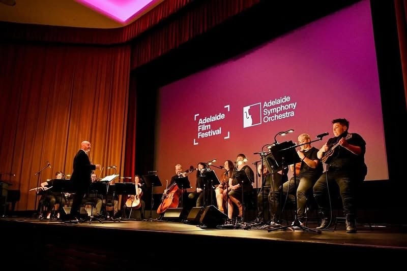 Julian Ferraretto leading an ensemble on stage at the Adelaide Film Festival with the Adelaide Symphony Orchestra