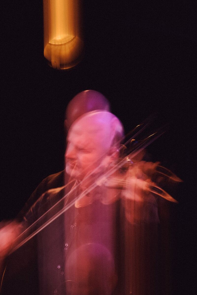 Julian Ferraretto performing under stage lights, motion blur