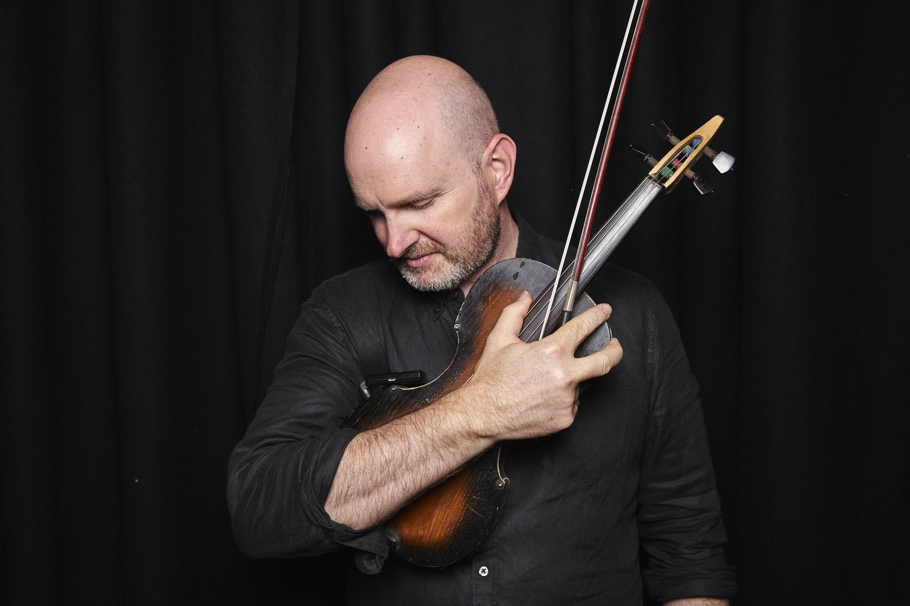 Julian Ferraretto with his Spur semi-acoustic violin
